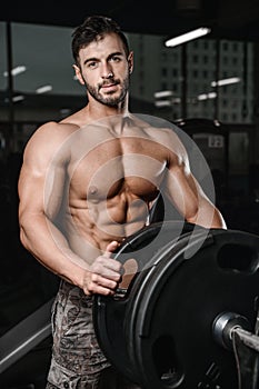 Strong and handsome athletic young man muscles abs and biceps