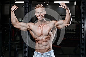 Strong and handsome athletic young man muscles abs and biceps fitness and bodybuilding