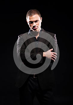 Strong and handsome man in suit over dark background