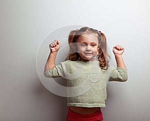 Strong happy successful girl showing muscular on blue background