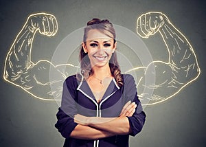 Strong happy young woman on gray background