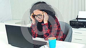 Strong headache during work at the office. Tired business woman at workplace. Hard working day. Woman having a headache.