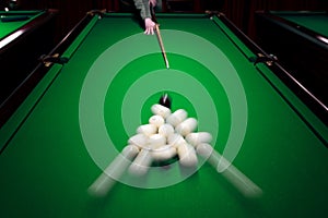 Strong hit by a player with a billiard cue on the ball