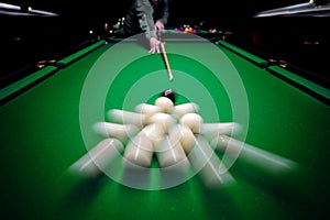 Strong hit by a player with a billiard cue on the ball