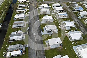 Strong hurricane winds severely damaged private houses in Florida mobile home residential area. Consequences of natural