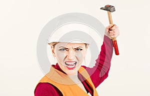 Strong and independent concept. Young woman works as builder. Woman with shouting face holds hammer, isolated on white