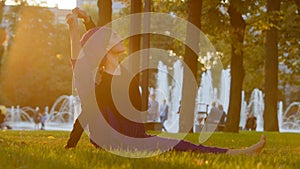 Strong islamic muslim indian woman in hijab active girl doing yoga in park outdoors training exercises tensing muscles