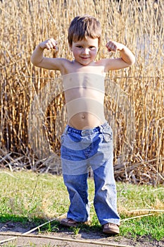 Strong kid showing the muscles