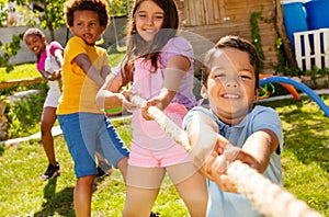 Strong kids pull rope in the competitive game