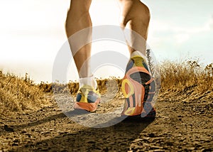Strong legs and shoes of sport man jogging in fitness training workout on off road
