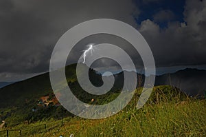 Strong lightning on mountaintop in the forest