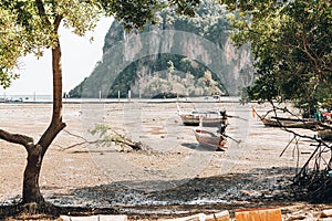 Strong low tide and drought on a tropical island. The boats are aground