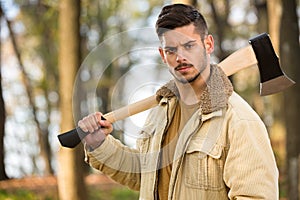 Strong lumberjack man holding axe