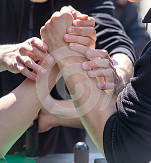 Strong male hands compete in arm wrestling