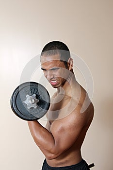 Strong male lifting dumbbell