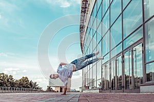Strong man acrobat dancer, handstand, breakdance dancing, summer city, free space text, hip hop dancer. Youth lifestyle