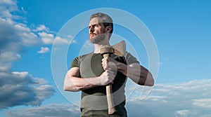 strong man with axe. caucasian man hold ax. brutally man on sky background