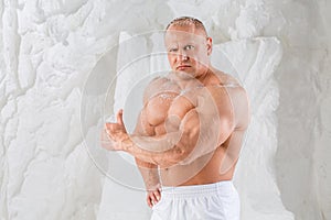 A strong man with big muscles showing thumbs