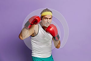 Strong Man Boxing In Gloves. Portrait of Senior Man Training