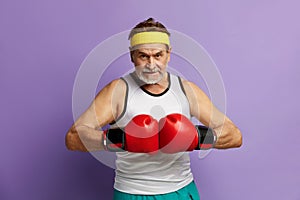 Strong Man Boxing In Gloves. Portrait of Senior Man Training