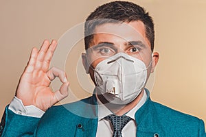 Strong man, businessman in tie and medical mask demonstrates confidence at work in pandemic coronavirus. Shows confidence and calm