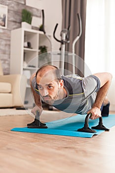 Strong man doing push ups on yoga mat