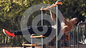 Strong Man Doing Statics Exercise On Horizontal Bar