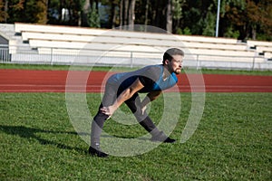 Strong man doing stretching before jogging