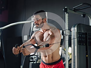 Strong man in the gym doing chest exercises