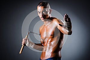 Strong man with nunchaku photo