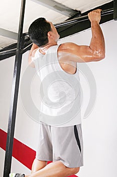 Strong man performing pull ups