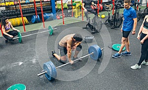 Strong man practicing weightlifting in the gym