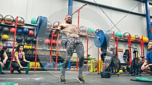 Strong man practicing weightlifting in the gym