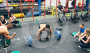 Strong man practicing weightlifting in the gym