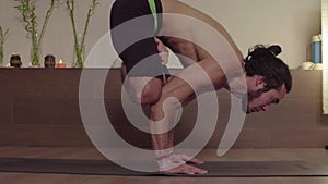 Strong man practicing yoga - Padmasana, Bakasana