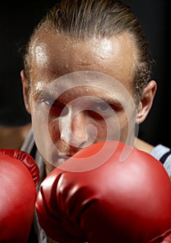 Strong man with red boxing gloves