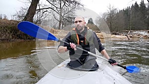 Strong man swim on Kayak On The River.Male Swimmimg On Canoe. Enjoying Views. wild nature