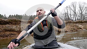 Strong man swim on Kayak On The River.Male Swimmimg On Canoe. Enjoying Views. wild nature