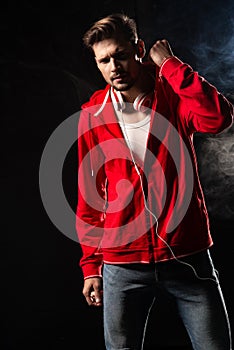 Strong man wear red hoodie over black background