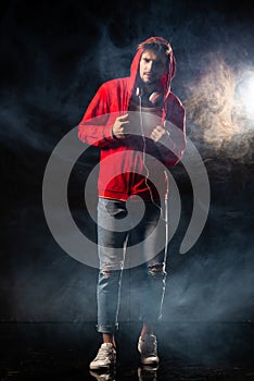 Strong man wear red hoodie over black background