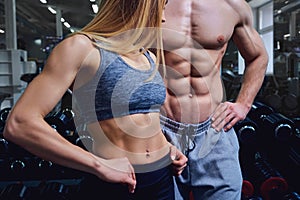 Strong man and a woman are posing with beautiful bodies.