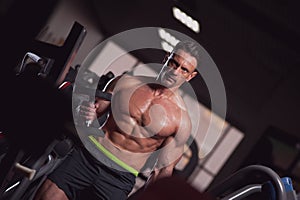 Strong mature man working out in the gym