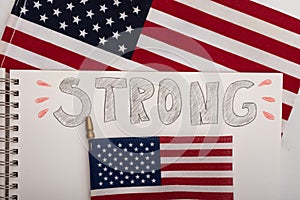 Strong message on spiral notebook USA flags on the background