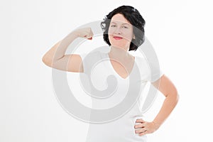 Strong middle age woman showing her muscularity and looking at camera isolated on white. Copy space and blank template t shirt