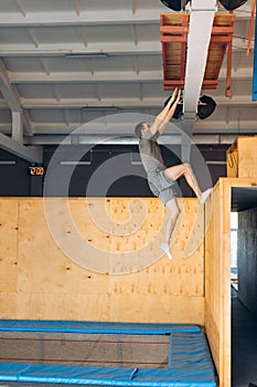 Strong motivated athlete climbing to the wall