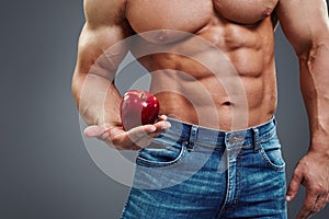 Strong Muscle Man holding a Red Apple