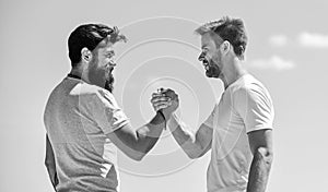 Strong and muscular arms. Successful deal handshake blue sky background. Men shaking hands at meeting. Friendly