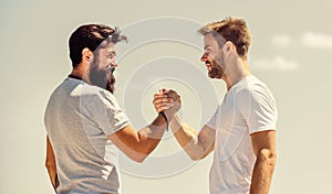 Strong and muscular arms. Successful deal handshake blue sky background. Men shaking hands at meeting. Friendly