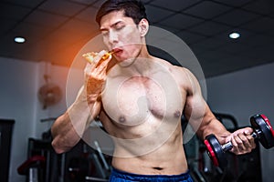 Strong muscular athlete men with pizza fast food. Unhealthy eating diet concept