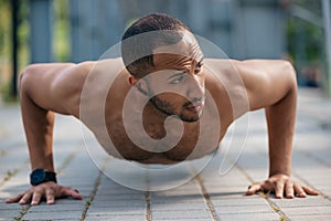 Strong muscular handsome man doing push ups